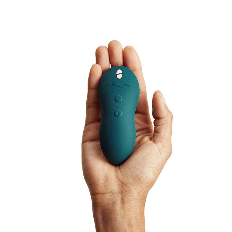We-Vibe Touch X Clitoral Stimulator in Green shown on palm of hand