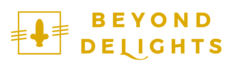 Beyond Delights logo in gold with spildo and lettering